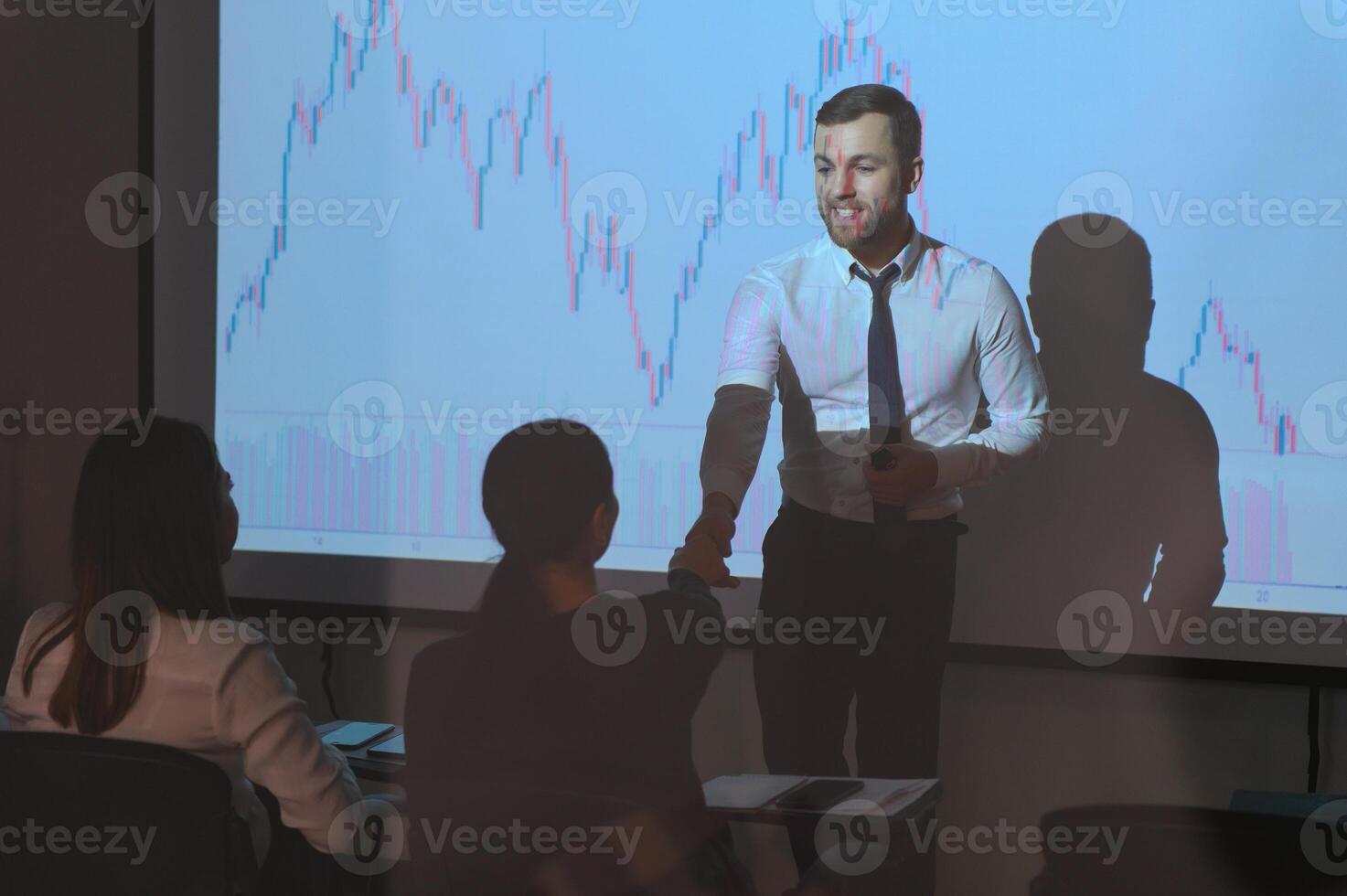 Group of business people working. Technical price graph and indicator, red and blue candlestick chart and stock trading computer screen background. Traders analyzing data photo