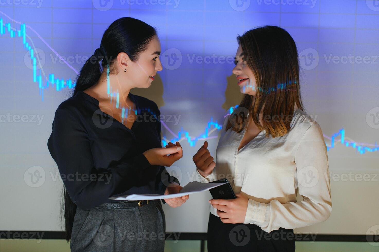 Group of business people working. Technical price graph and indicator, red and blue candlestick chart and stock trading computer screen background. Traders analyzing data photo