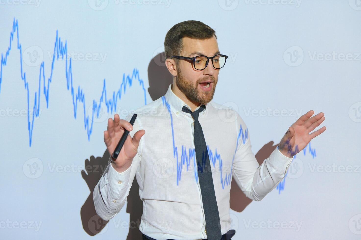 Portrait of concerned European businessman thinking in blurry office with double exposure of falling financial chart. Concept of crisis and stock market. photo