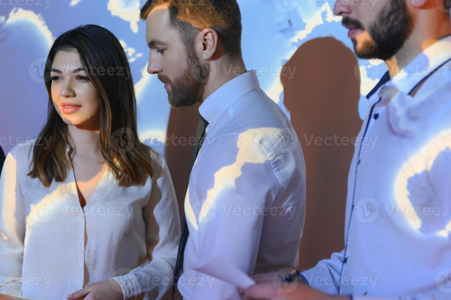Image of businesspeople standing against world map background photo