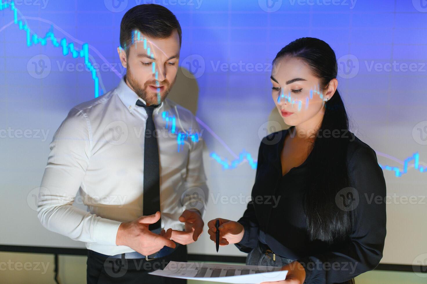 Group of business people working. Technical price graph and indicator, red and blue candlestick chart and stock trading computer screen background. Traders analyzing data photo