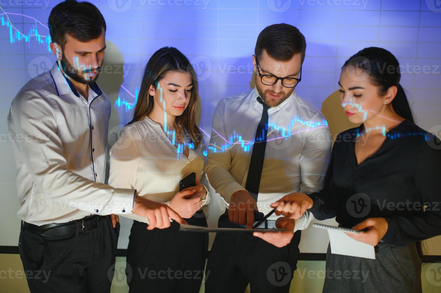 Group of business people working. Technical price graph and indicator, red and blue candlestick chart and stock trading computer screen background. Traders analyzing data photo