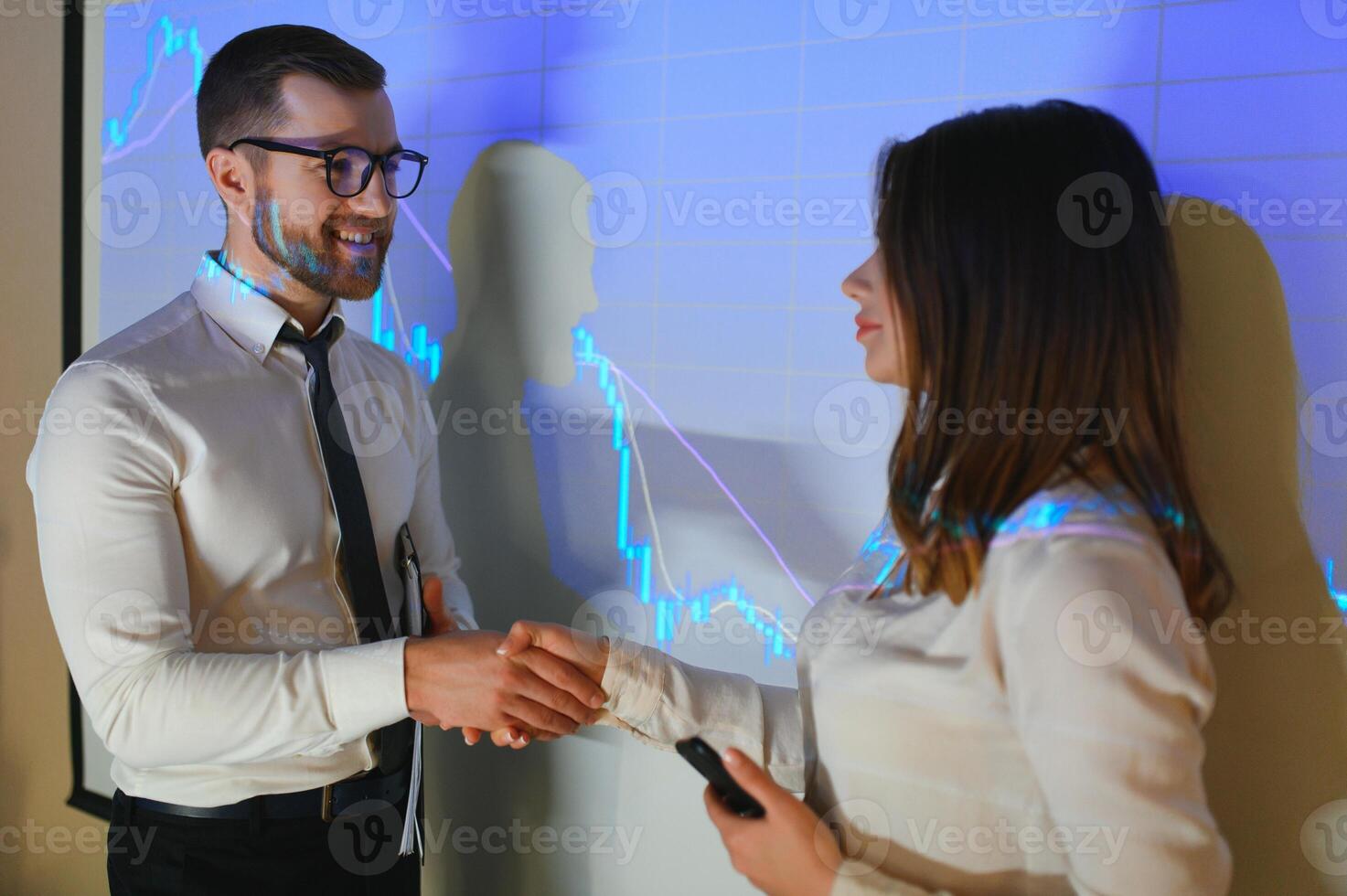 Group of business people working. Technical price graph and indicator, red and blue candlestick chart and stock trading computer screen background. Traders analyzing data photo
