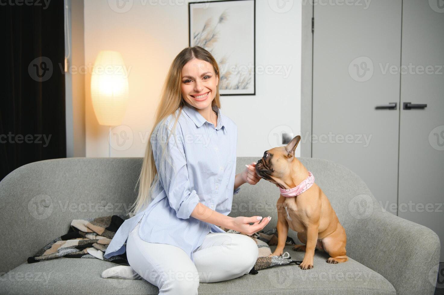 Young woman with her cute dog at home. Lovely pet photo