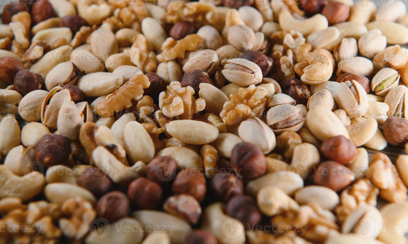 Background of various nuts almond, cashew, hazelnut, pistachio, walnut. Vegetarian meal. Healthy eating concept photo