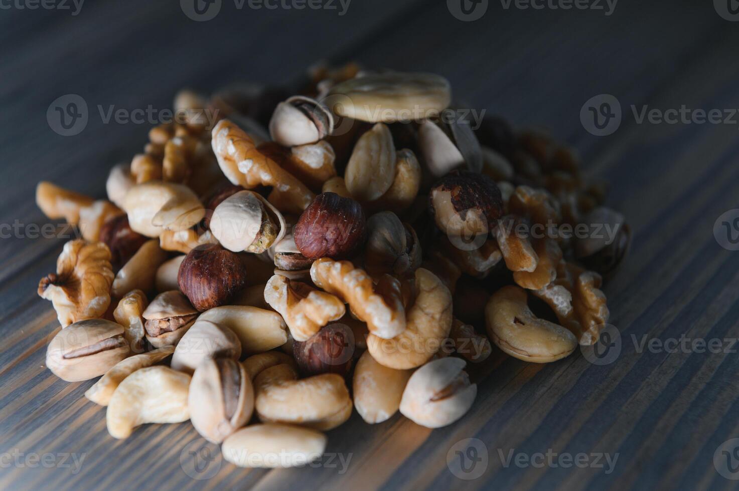 Mixed nuts on wood floor. Organic and fresh nuts. Copy space photo