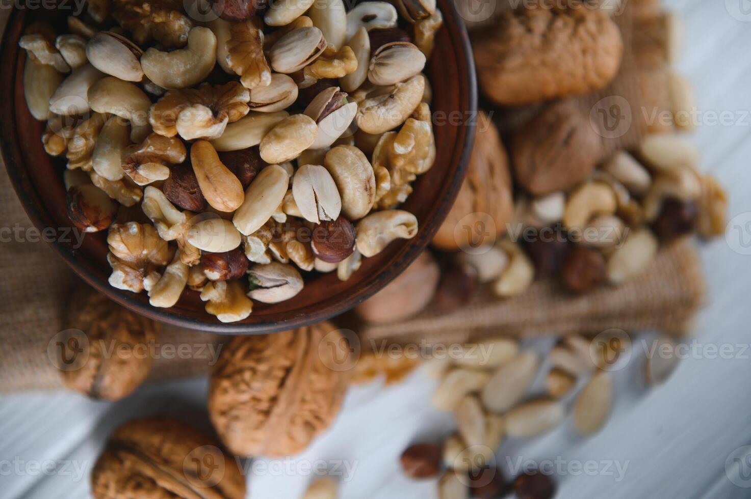 Various nuts on a plate, top view. photo