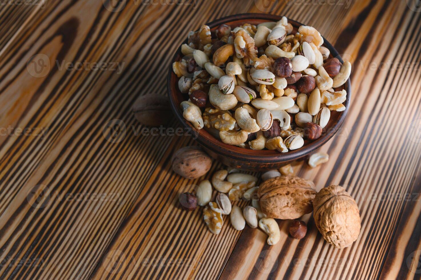Various nuts on a plate, top view. photo