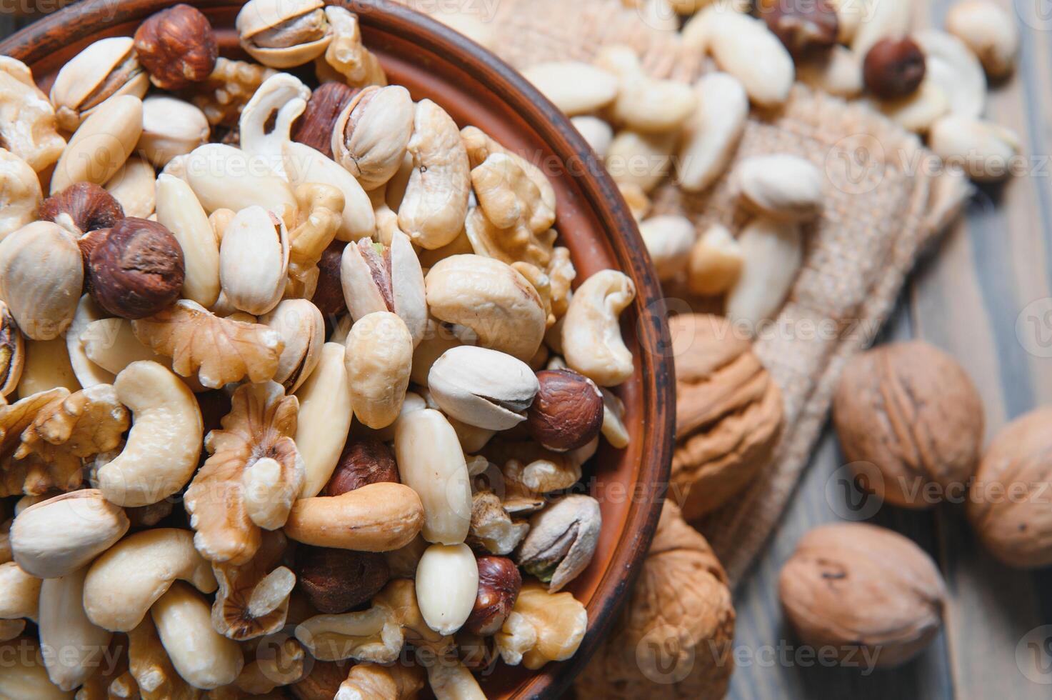 Various nuts on a plate, top view. photo