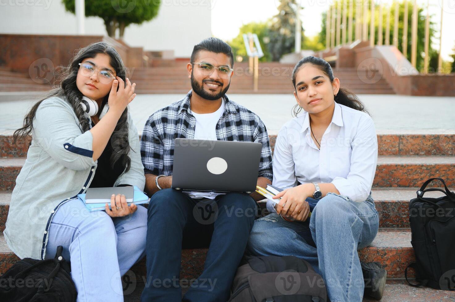 group of young students checking exam results or waiting for project approval on laptop at collage campus photo