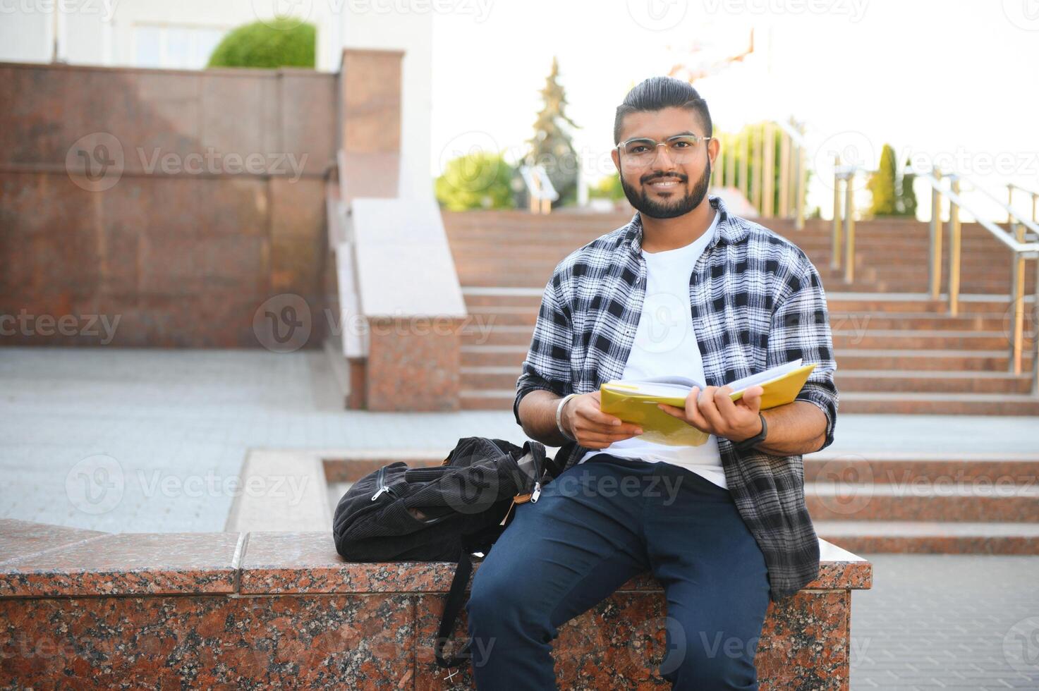 Happy indian male student at the university photo