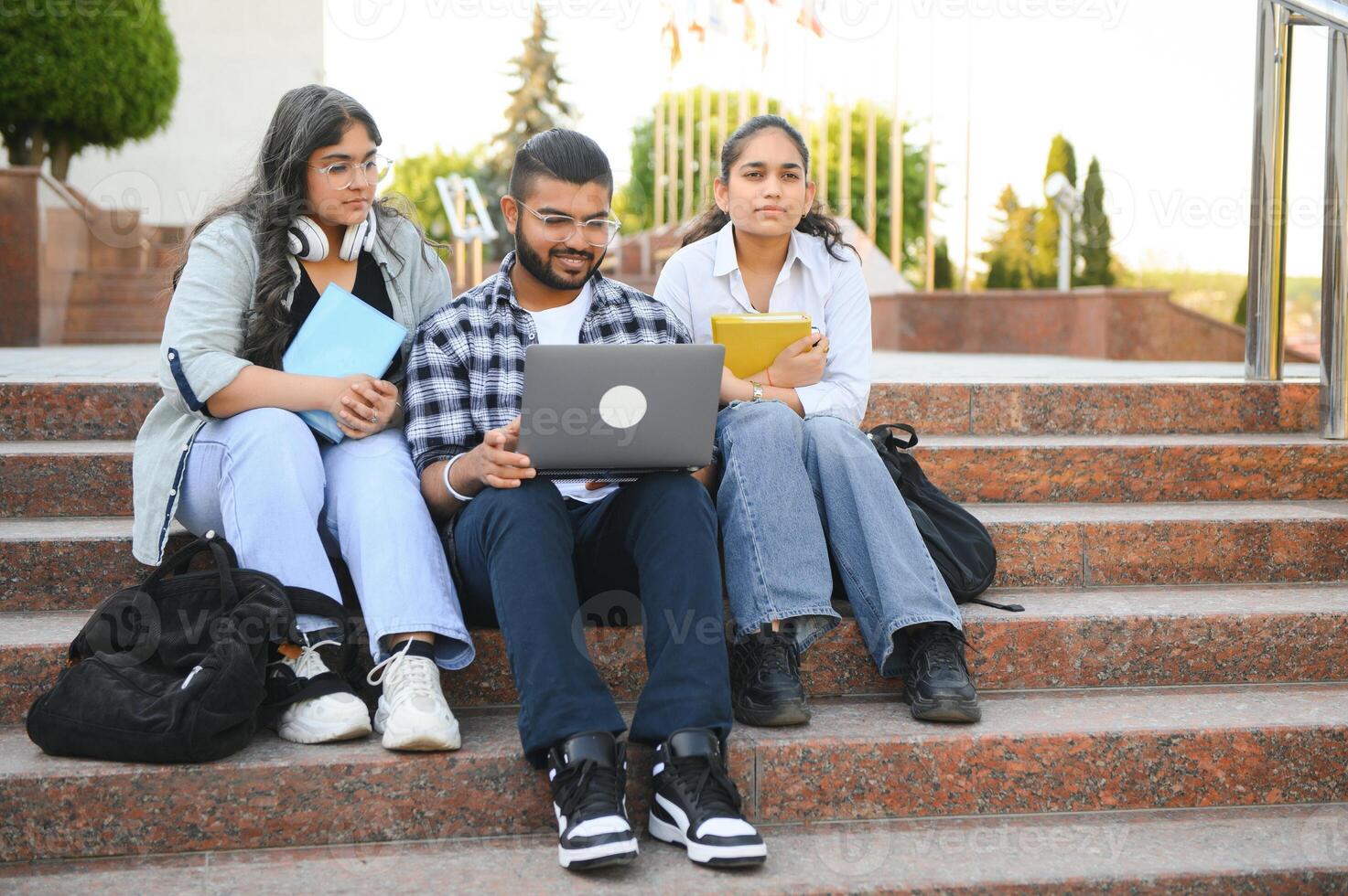 Group of smiling multiethnic near university campus photo