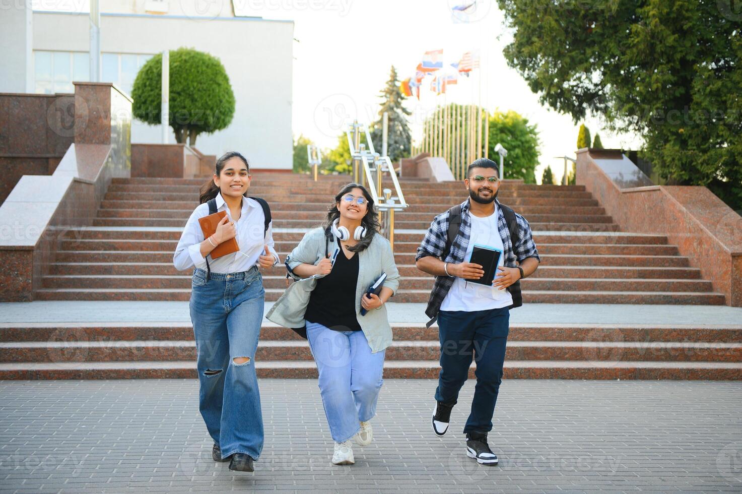 Group of smiling multiethnic near university campus photo
