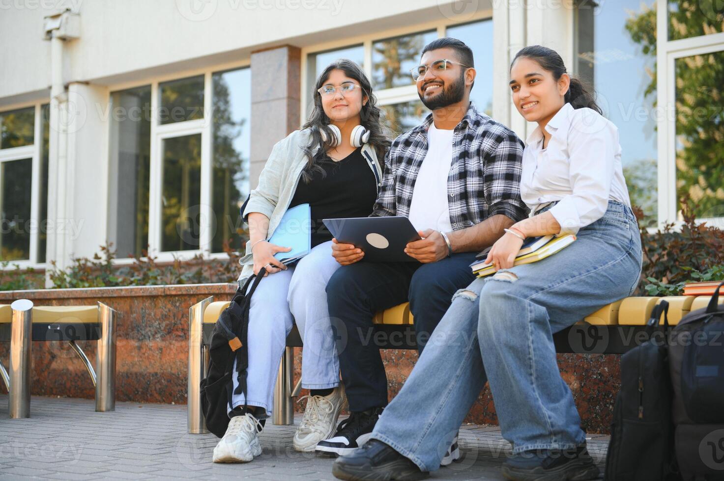 group of young students checking exam results or waiting for project approval on laptop at collage campus photo