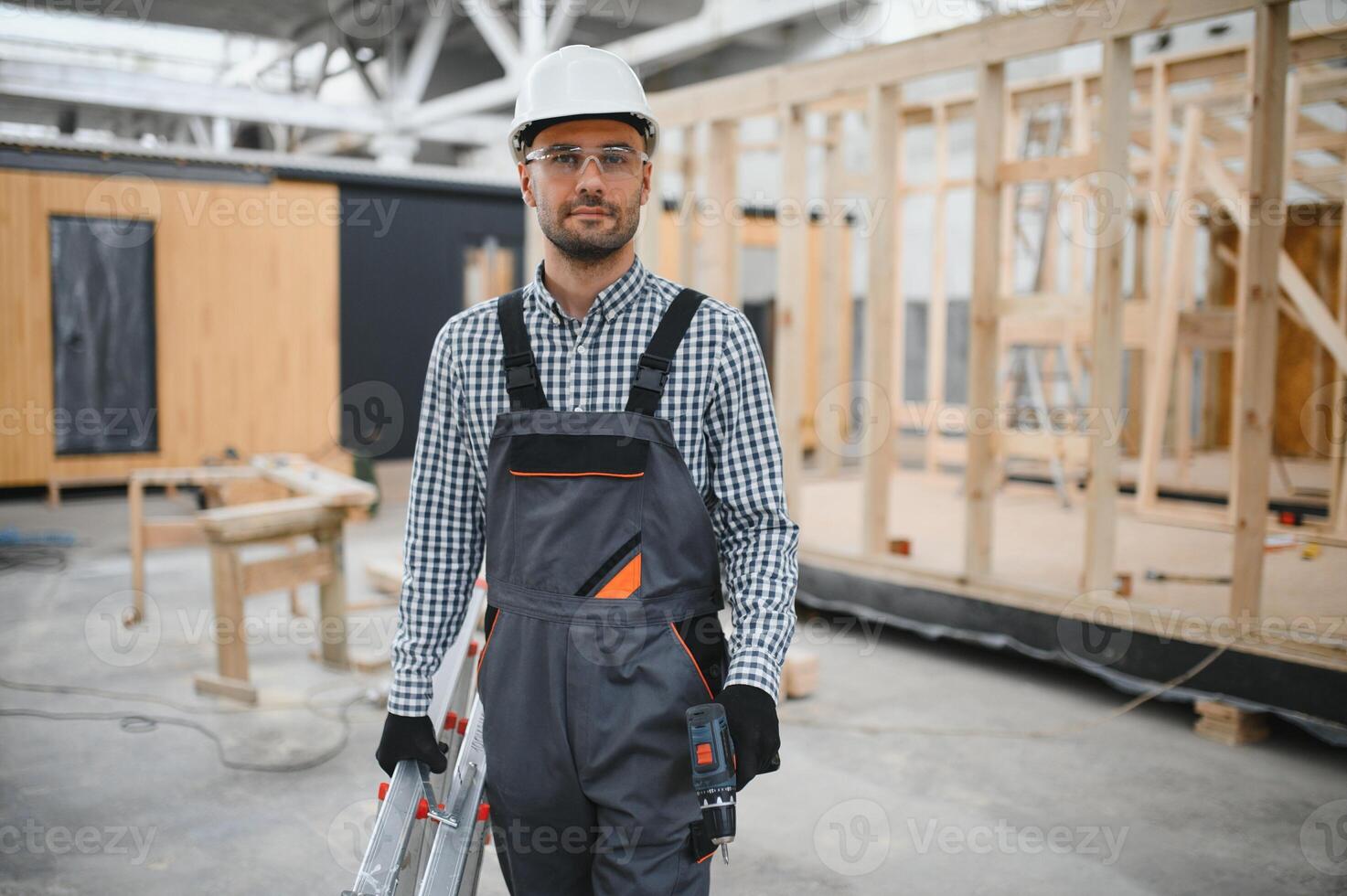 Worker carpenter assembling a modular house photo