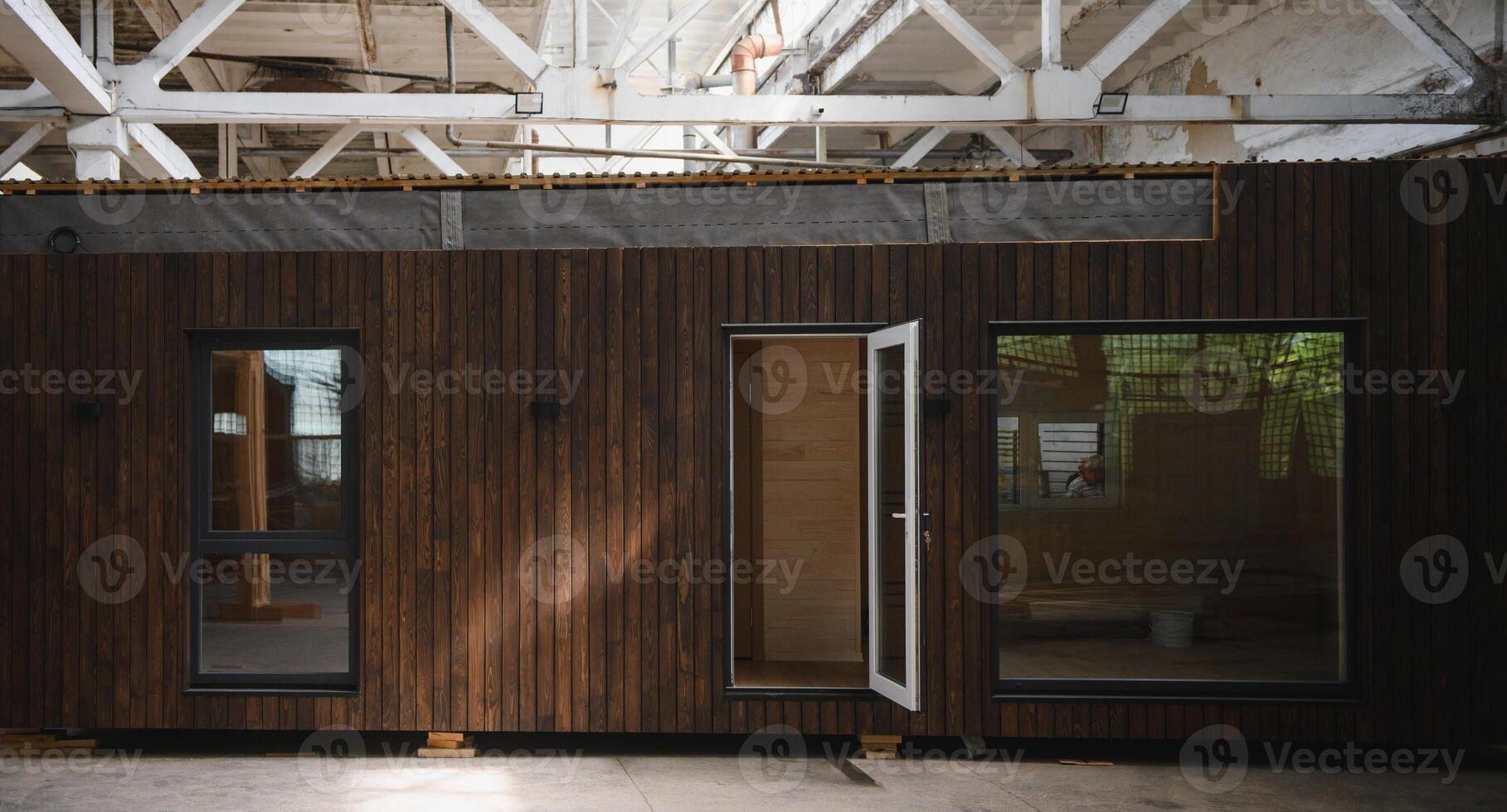 Newly built single storey prefabricated modular building. Prefabricated mobile wooden house at construction site photo