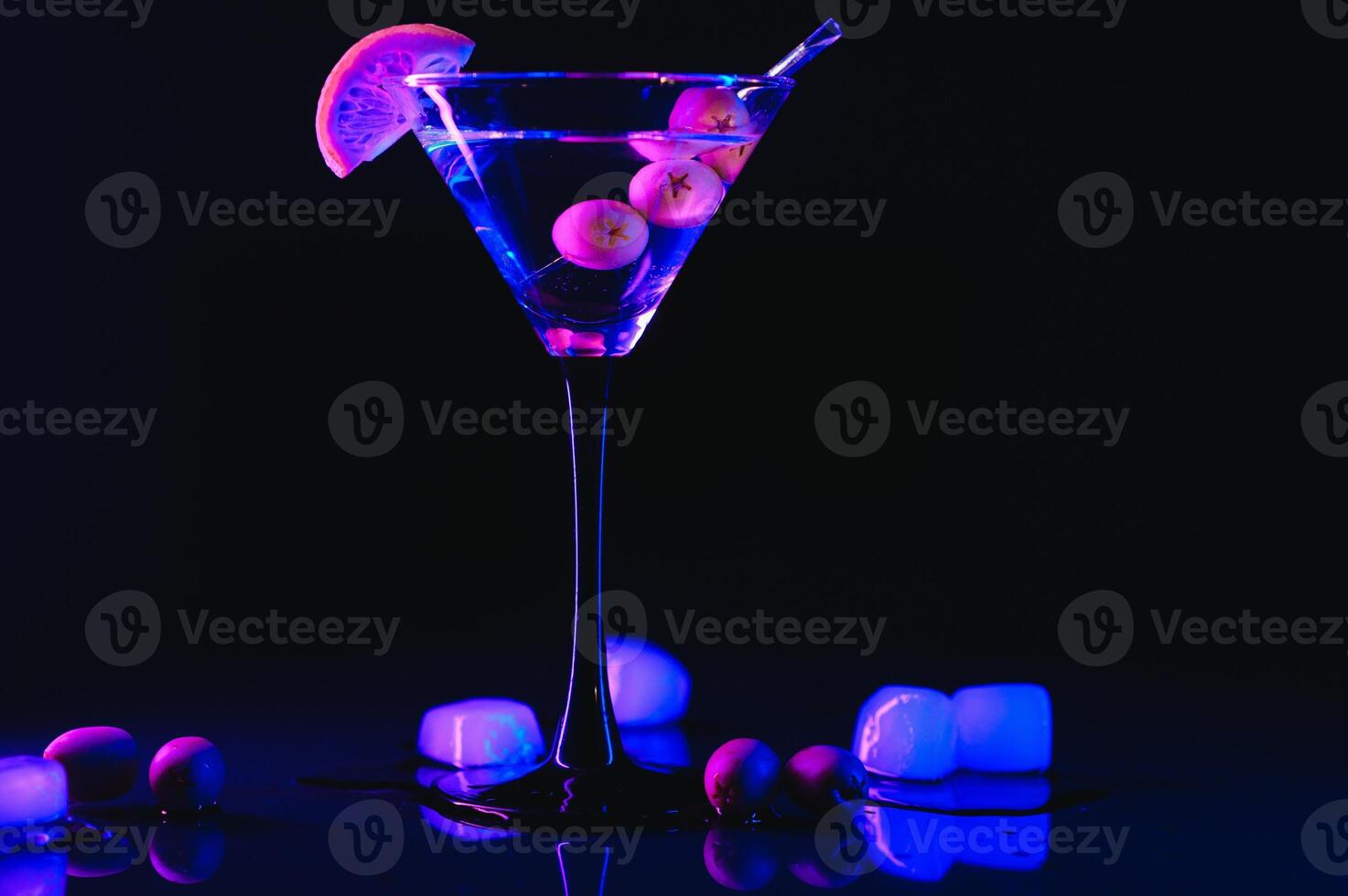 Glass of classic dry martini cocktail with olives on dark table against black background. With free space for your text photo