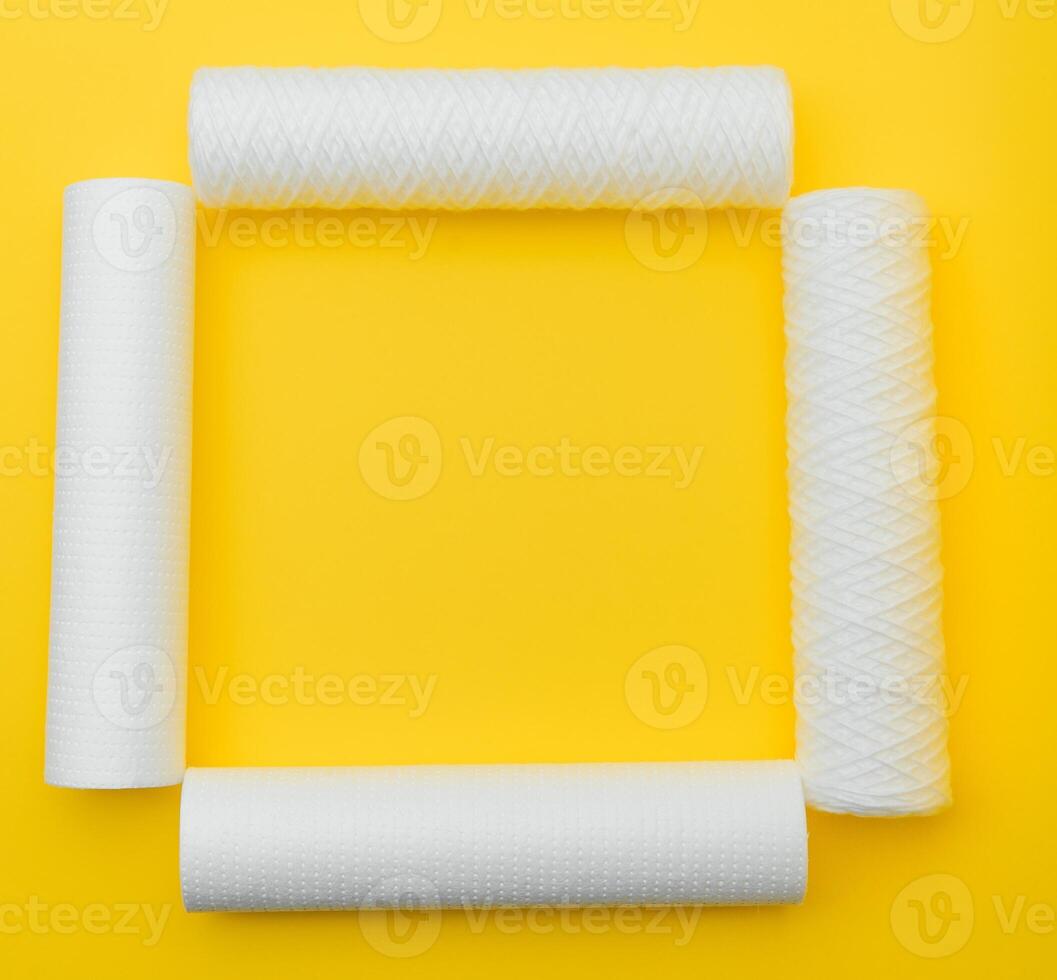 Cartridges for water treatment systems on yellow background. photo