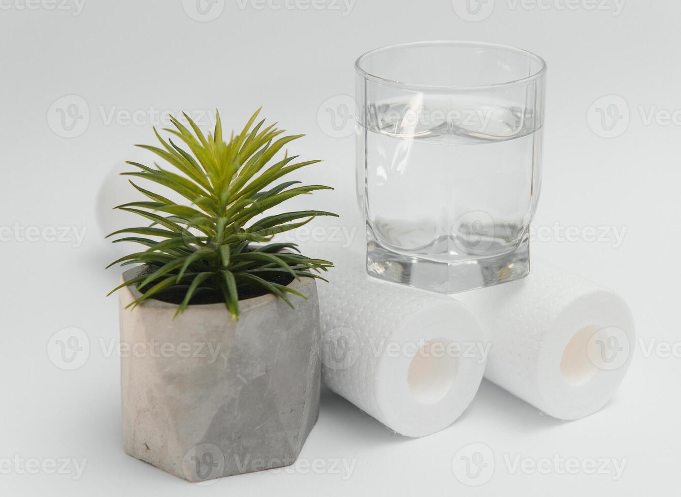 Water filters. Carbon cartridges and a glass on a white background. Household filtration system photo