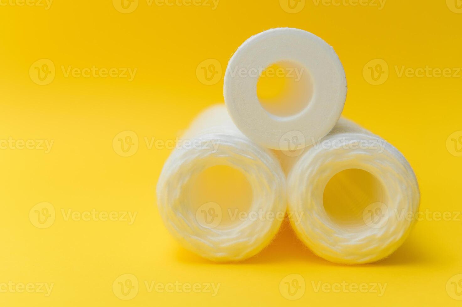 cartridges for water purification on a yellow background. Concept of clean water at home photo