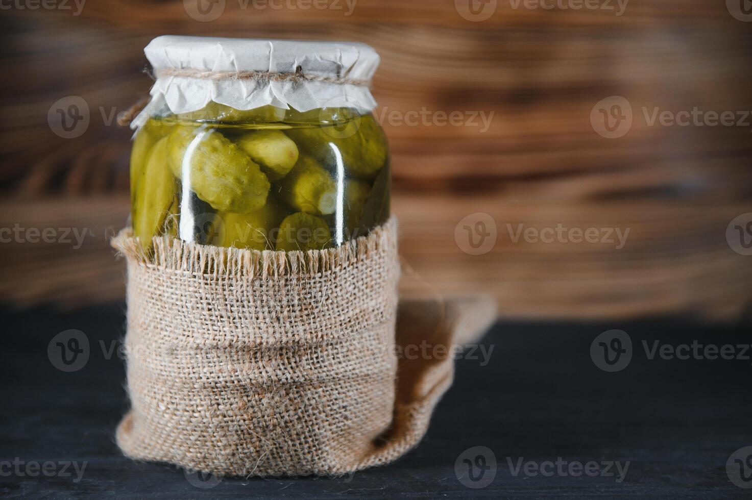 Pickled cucumbers in the jar. Ingredients for pickling cucumbers. Cucumbers, dill, garlic. Glass jars with pickles photo