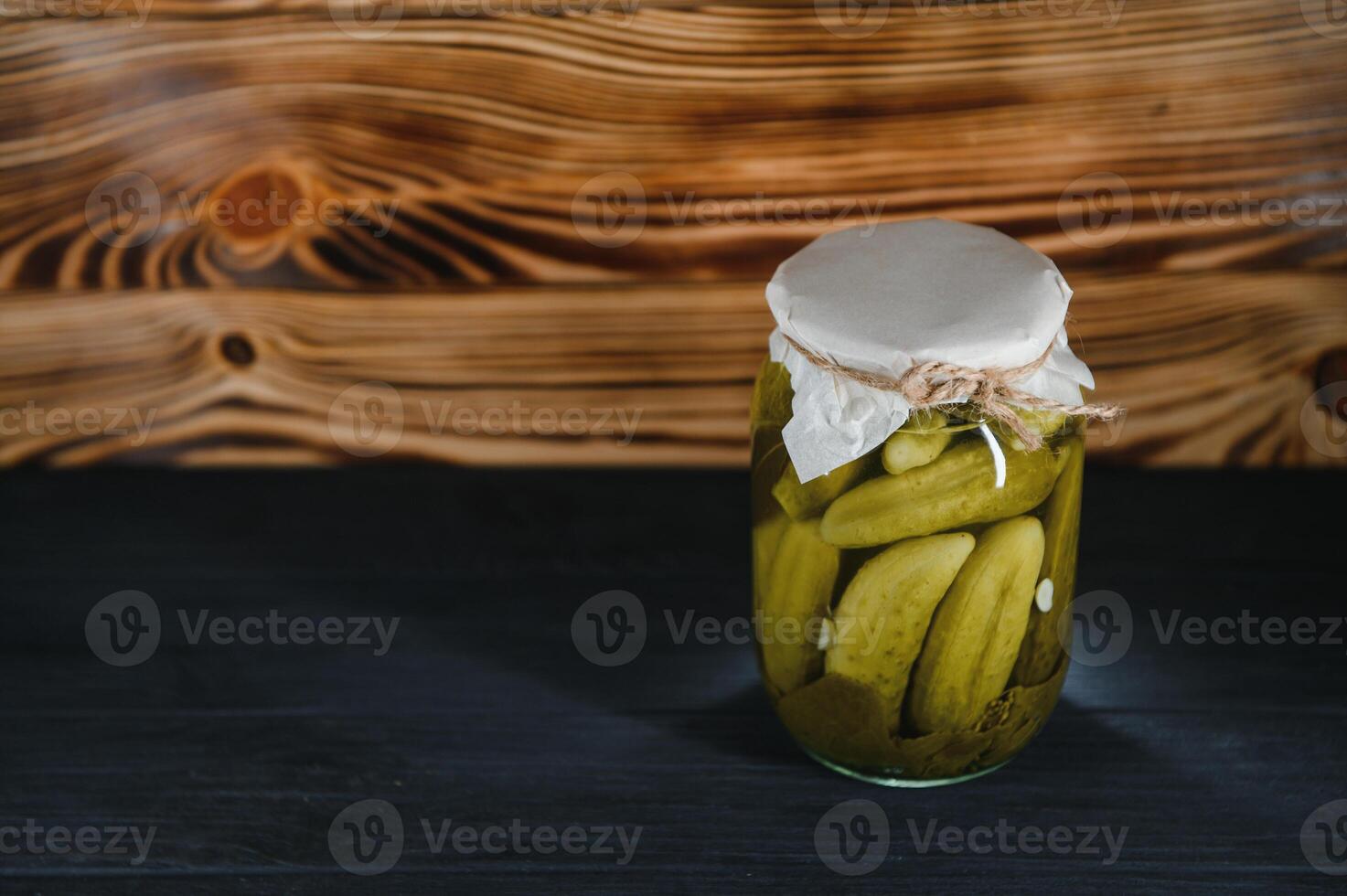 Pickled cucumbers in the jar. Ingredients for pickling cucumbers. Cucumbers, dill, garlic. Glass jars with pickles photo