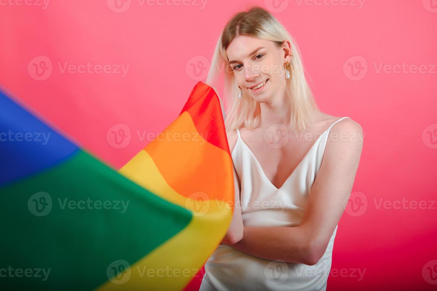 Young transgender woman on red background. photo