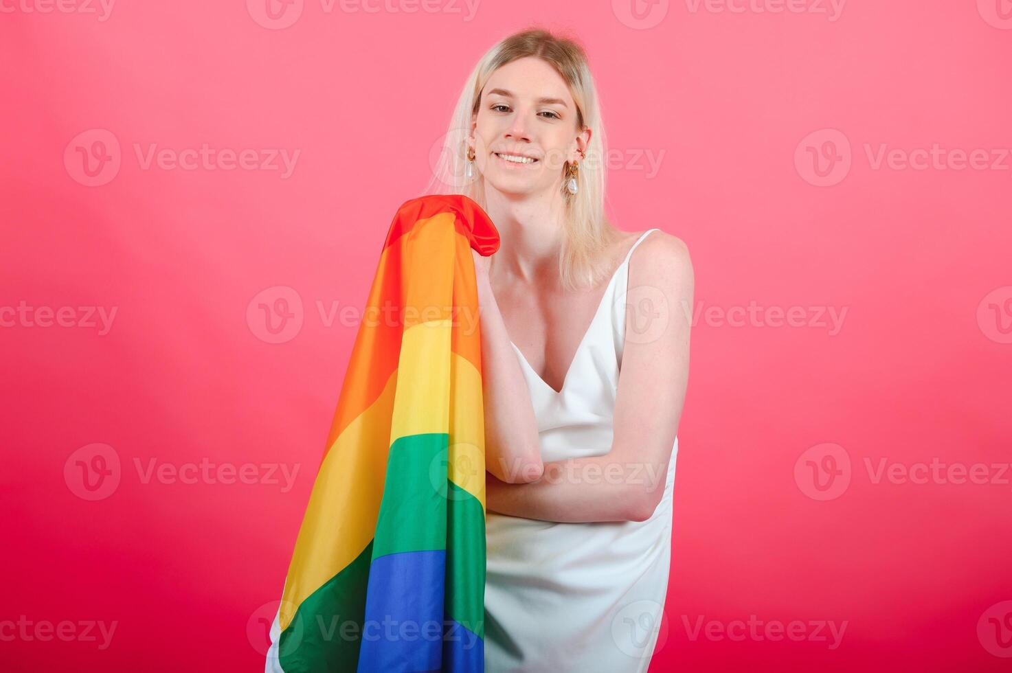 Young transgender woman on red background. photo
