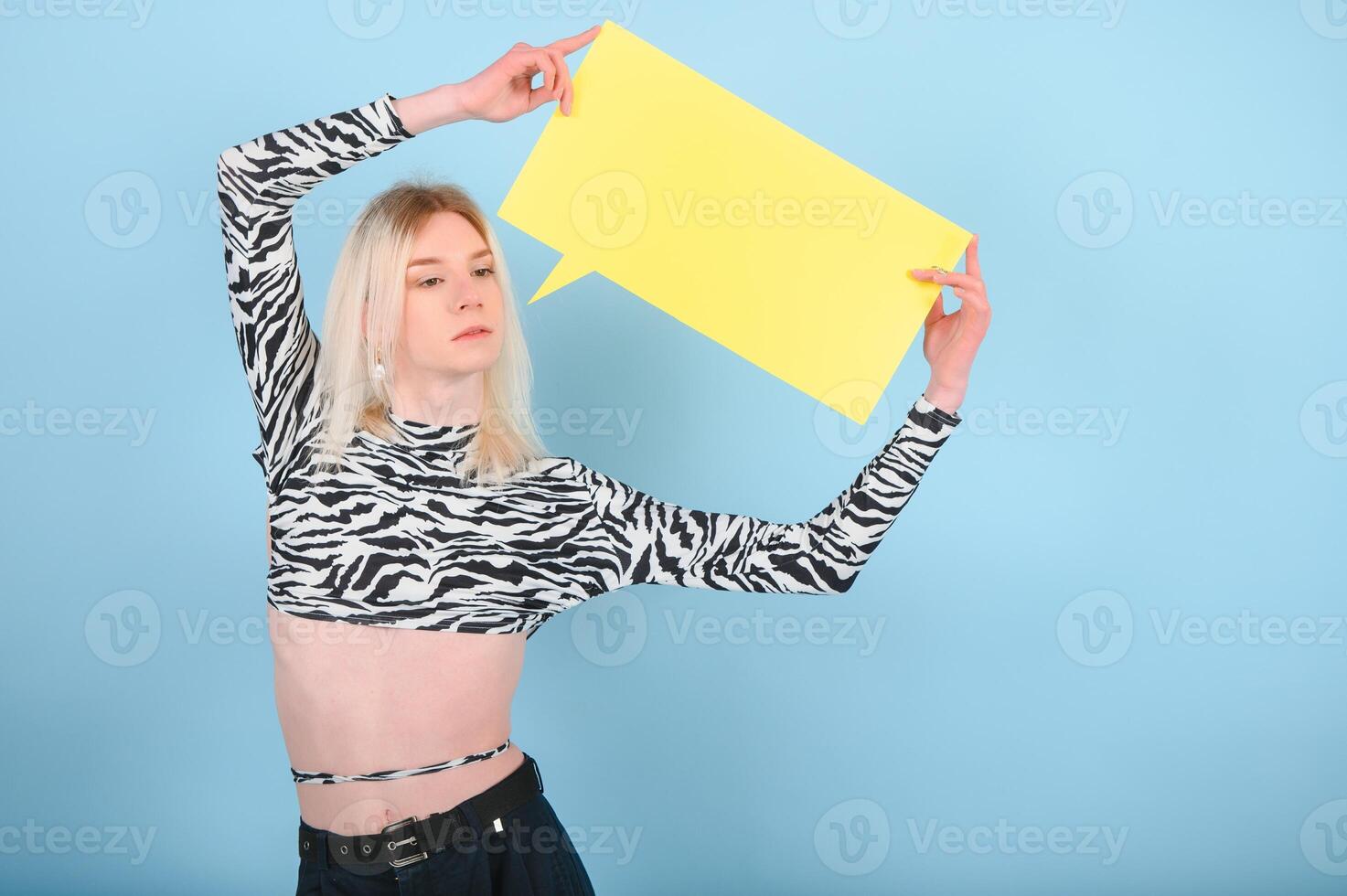 Fashionable young transgender woman on color background photo