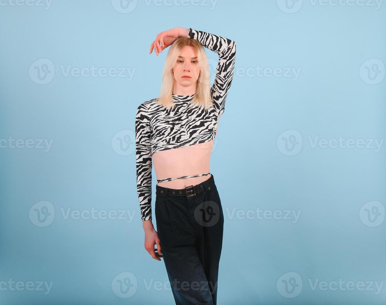 Young gay man 20s with make up isolated on a colored background, studio portrait. People lifestyle fashion lgbtq concept. photo