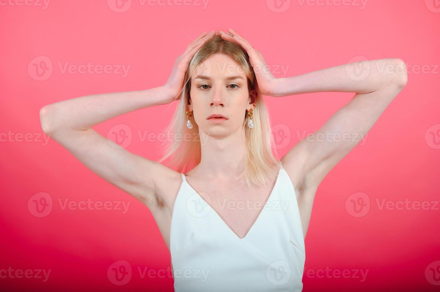 Fashionable young transgender woman on color background photo