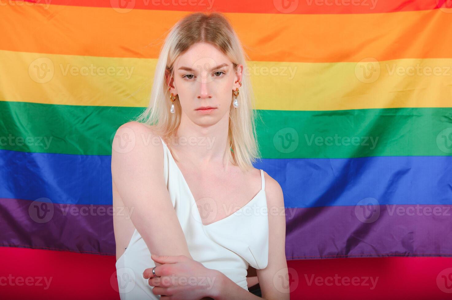 Fashionable young transgender woman on color background photo