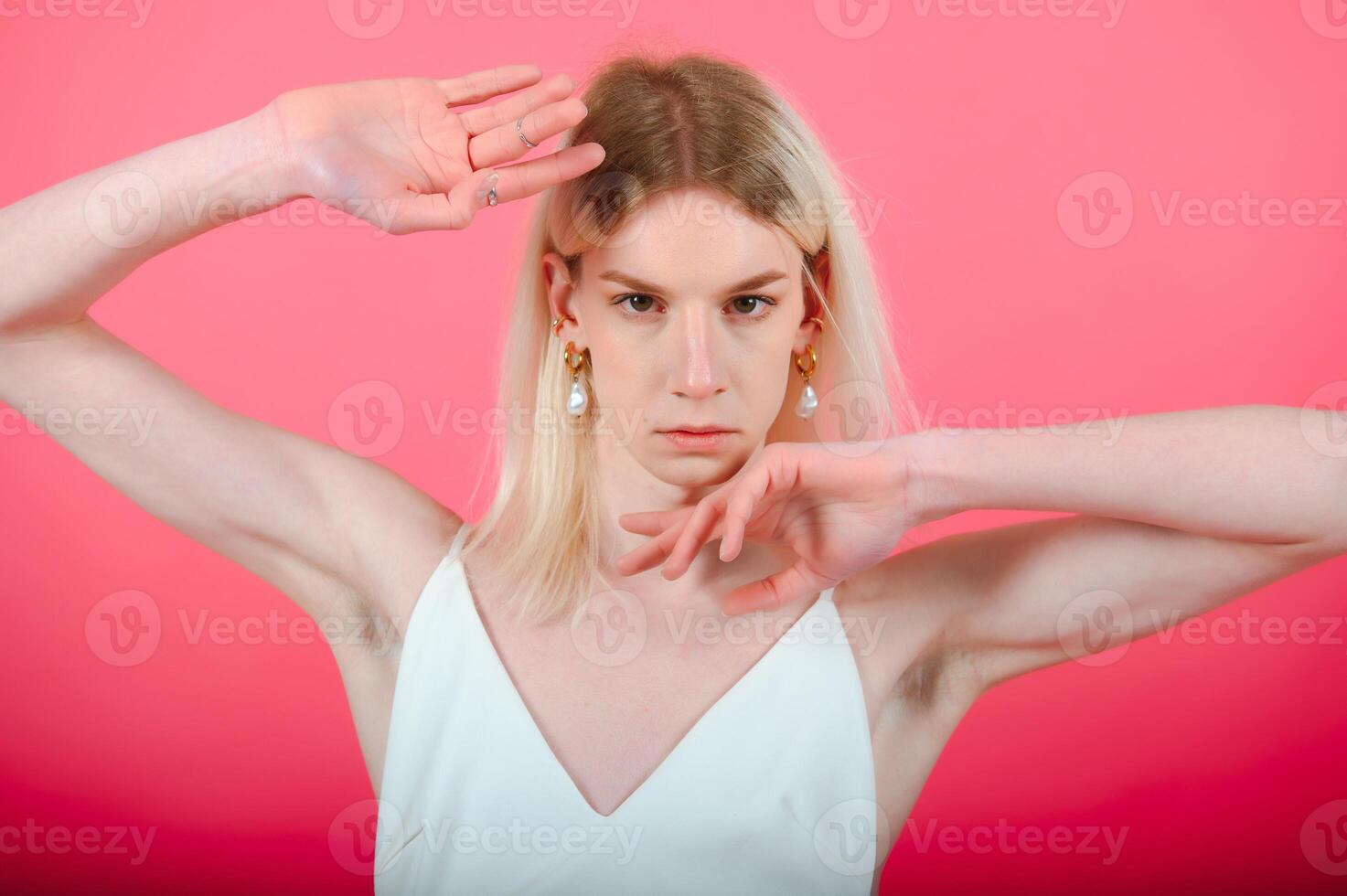 Portrait of young transgender woman on color background photo