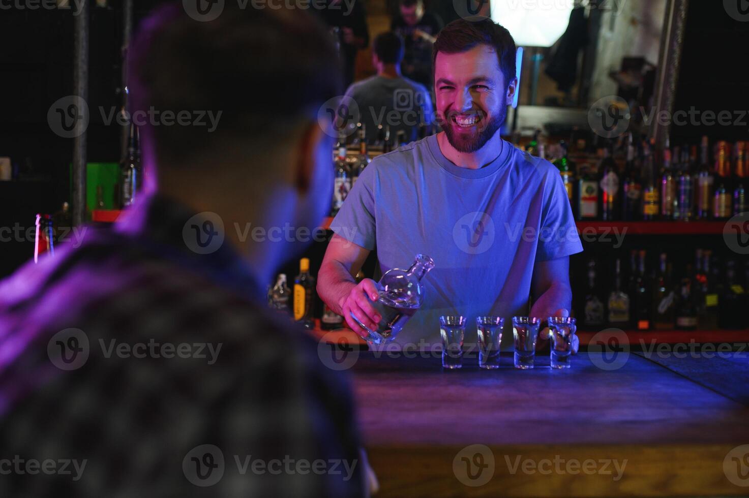 Portrait Of Smiling Male Bar Owner Standing Behind Counter photo