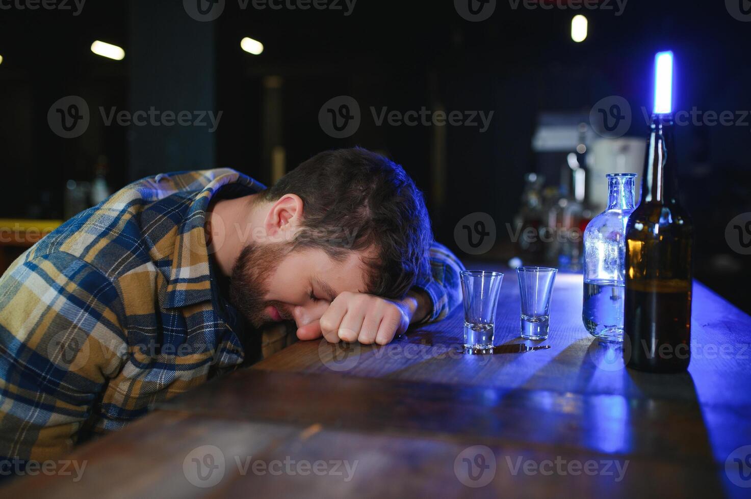 Sad man sitting at bar counter, alcohol addiction photo