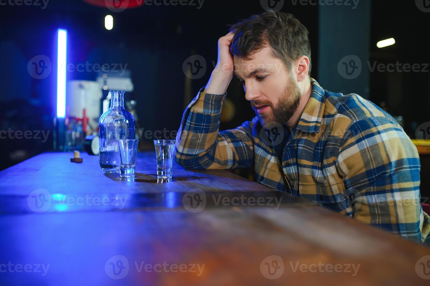 Young drunk man in bar photo