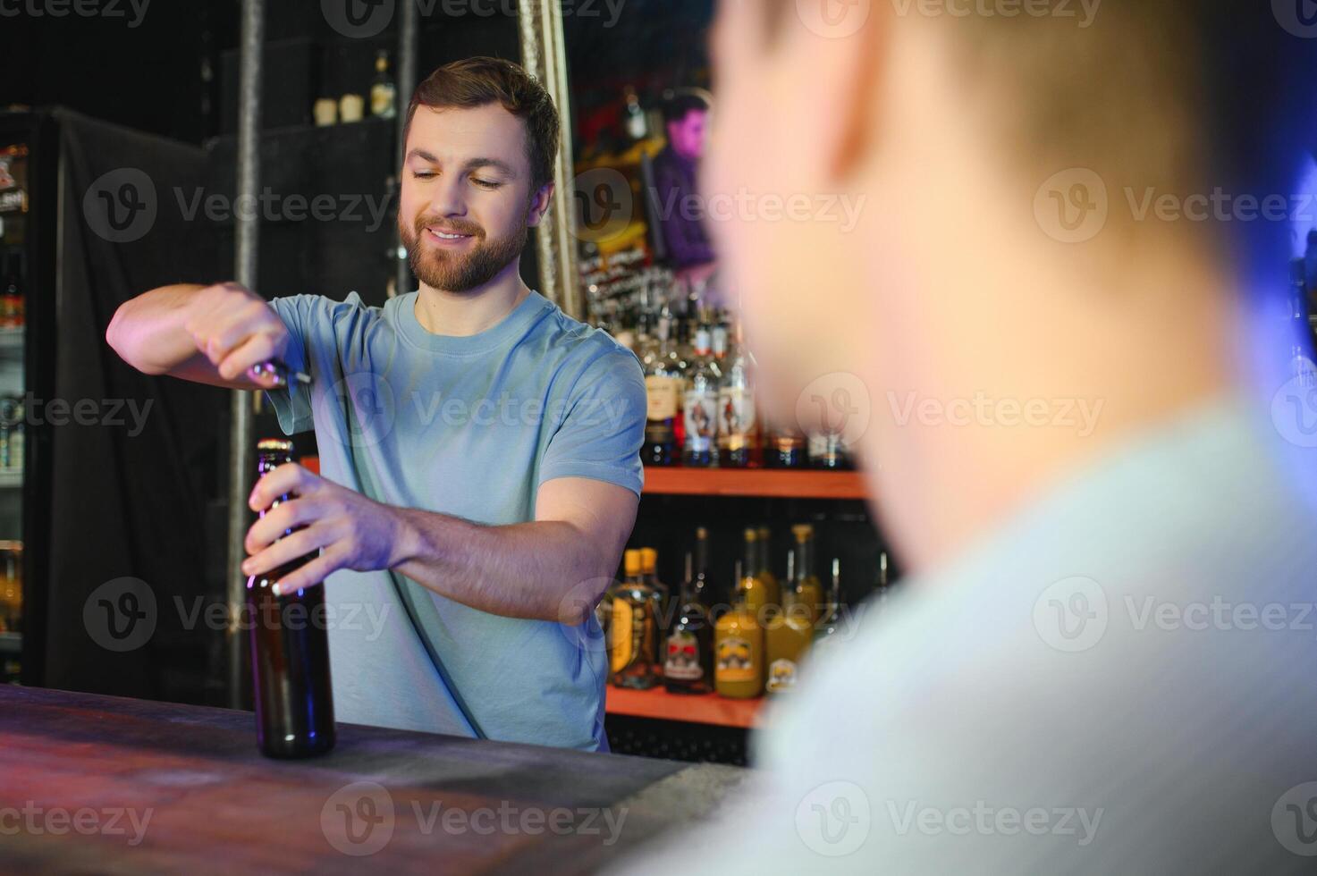Portrait Of Smiling Male Bar Owner Standing Behind Counter photo