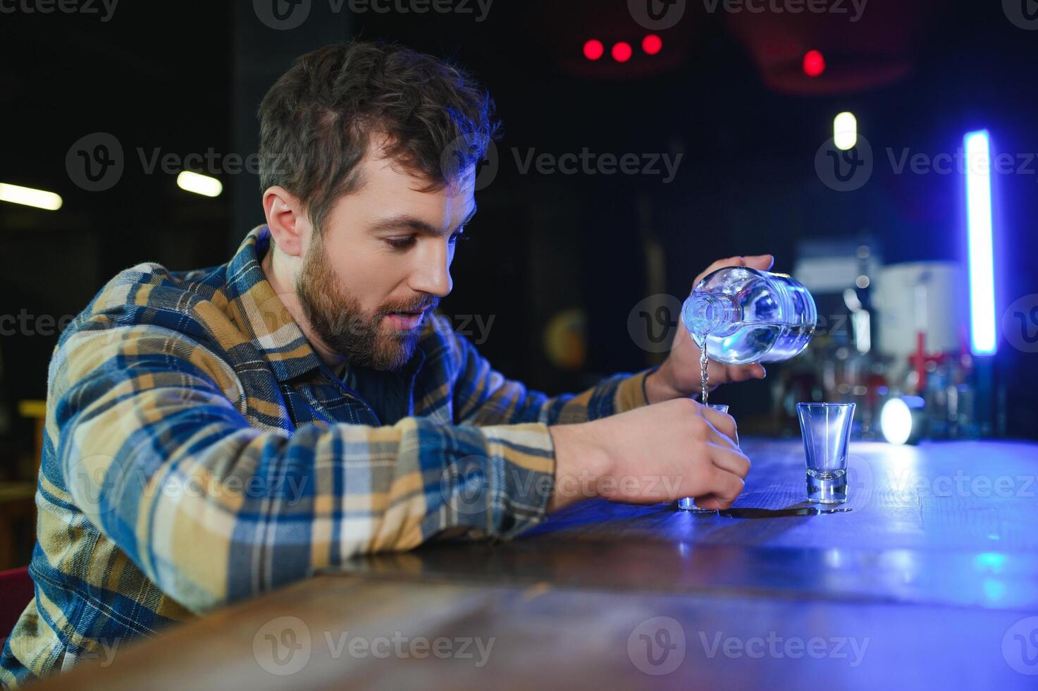 Sad man sitting at bar counter, alcohol addiction photo