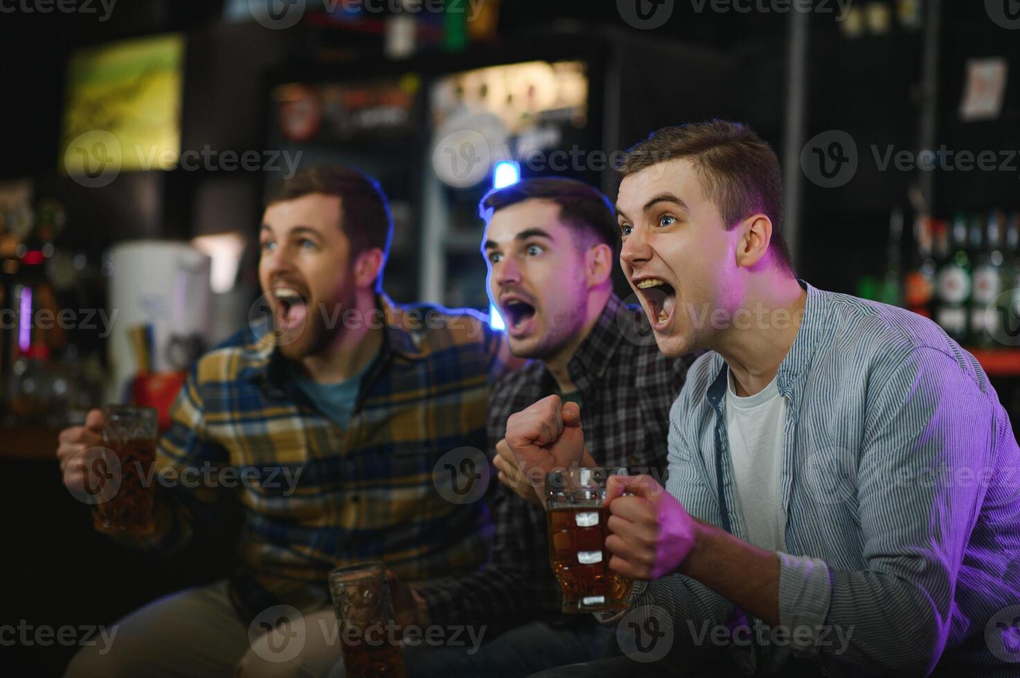 Sport, people, leisure, friendship, entertainment concept - happy male football fans or good yuong friends drinking beer, celebrating victory at bar or pub. Human positive emotions concept photo