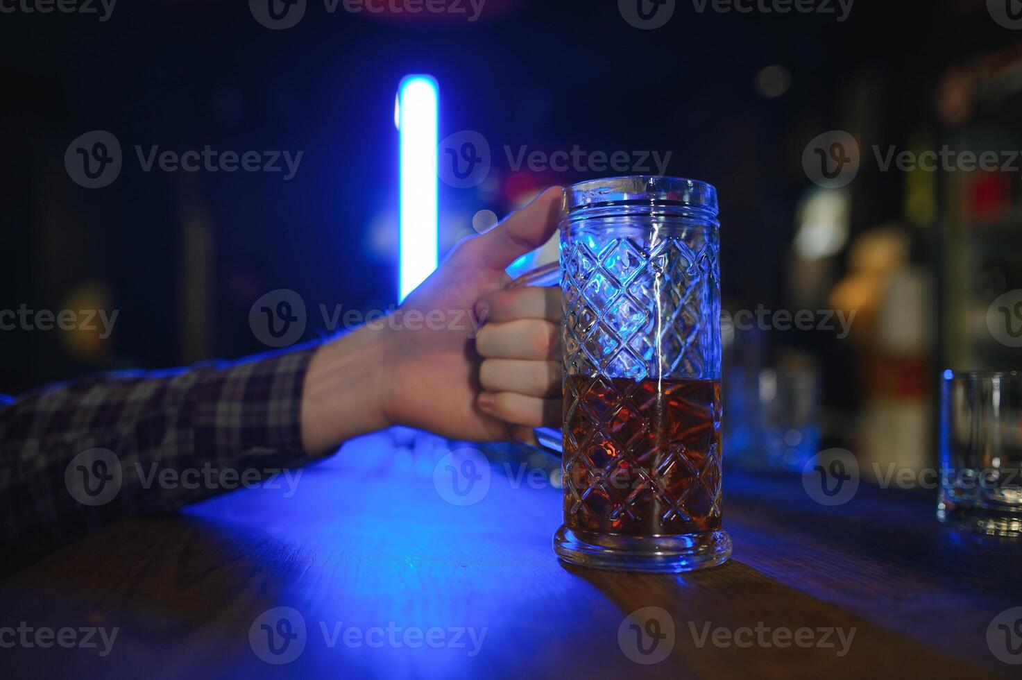 Tasting a good beer. Portrait of thoughtful men drinking beer at the bar photo