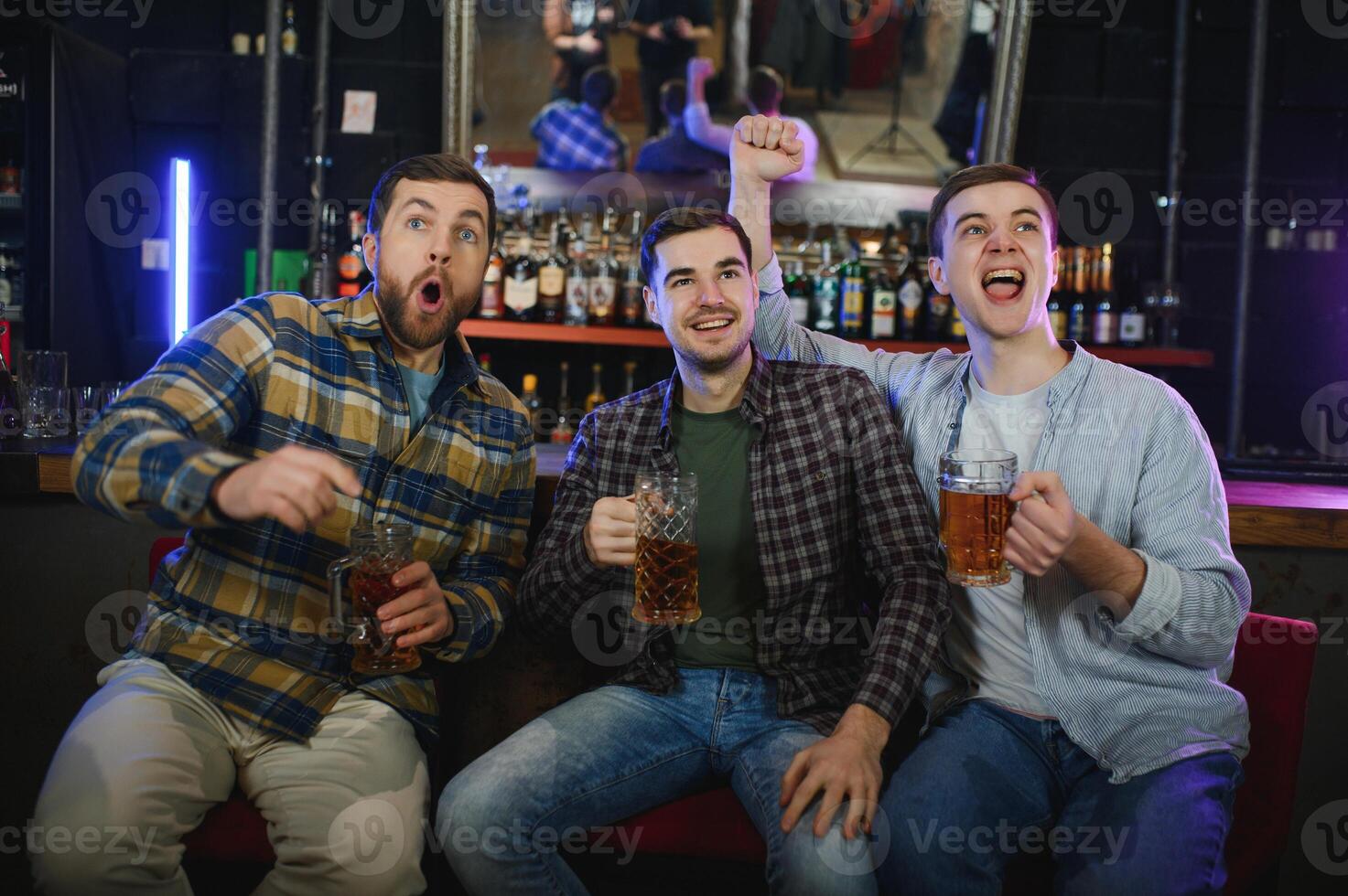 Sport, people, leisure, friendship, entertainment concept - happy male football fans or good yuong friends drinking beer, celebrating victory at bar or pub. Human positive emotions concept photo