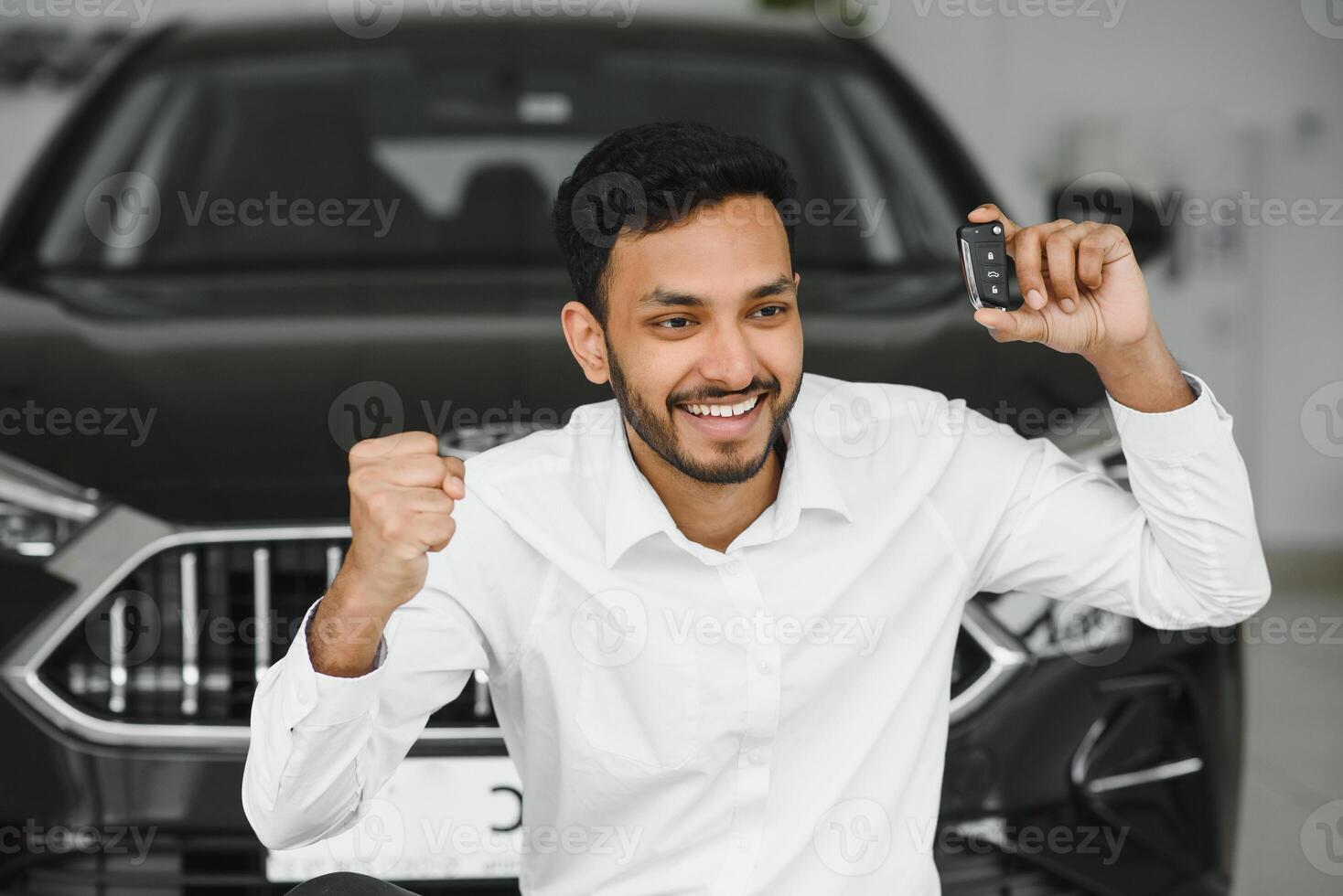 Closeup portrait happy, smiling, young man, buyer showing keys of his new car photo