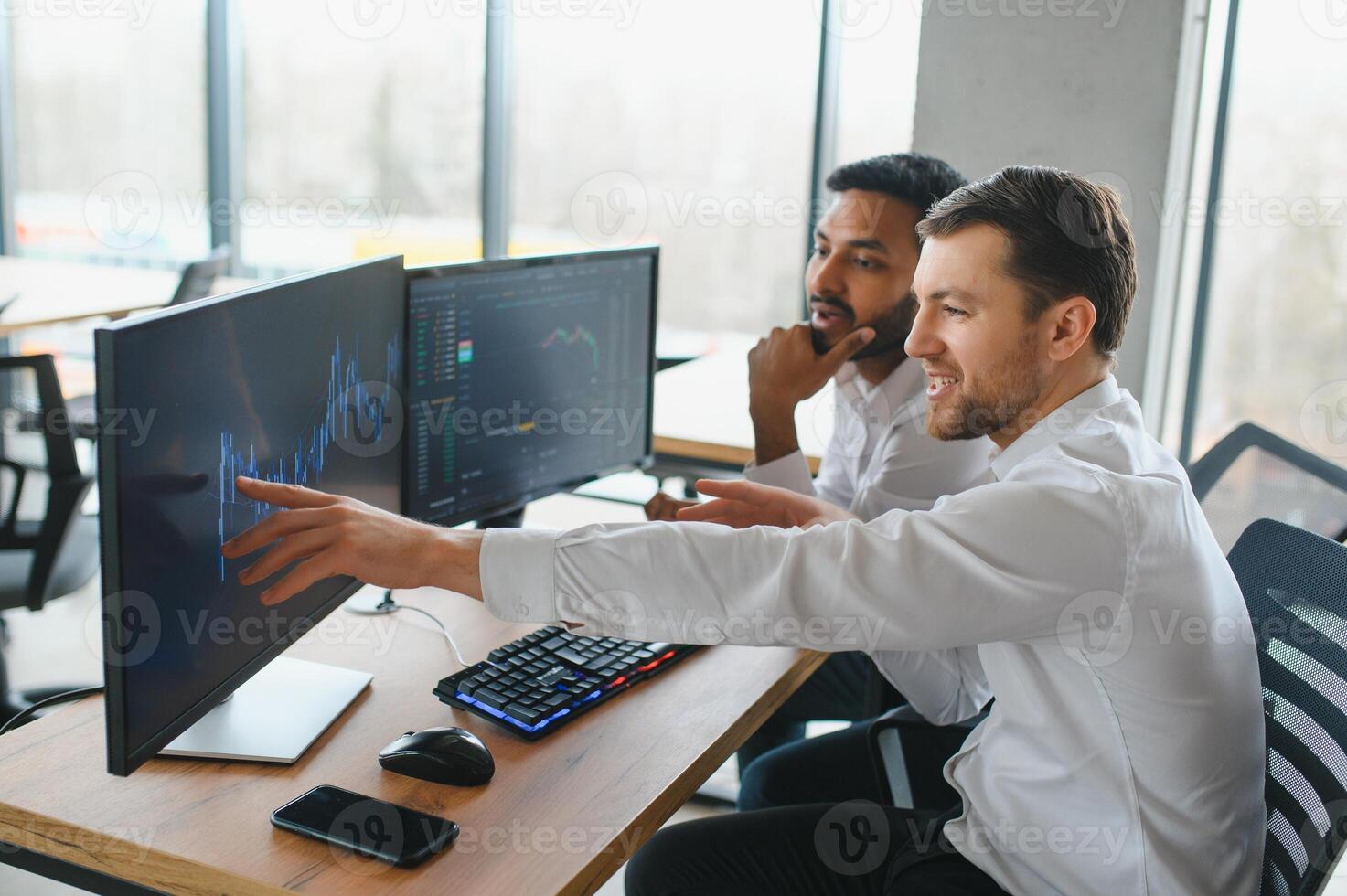 Two successful trader in formalwear pointing at display, analyzing stat and dynamic on forex charts, working in office together photo