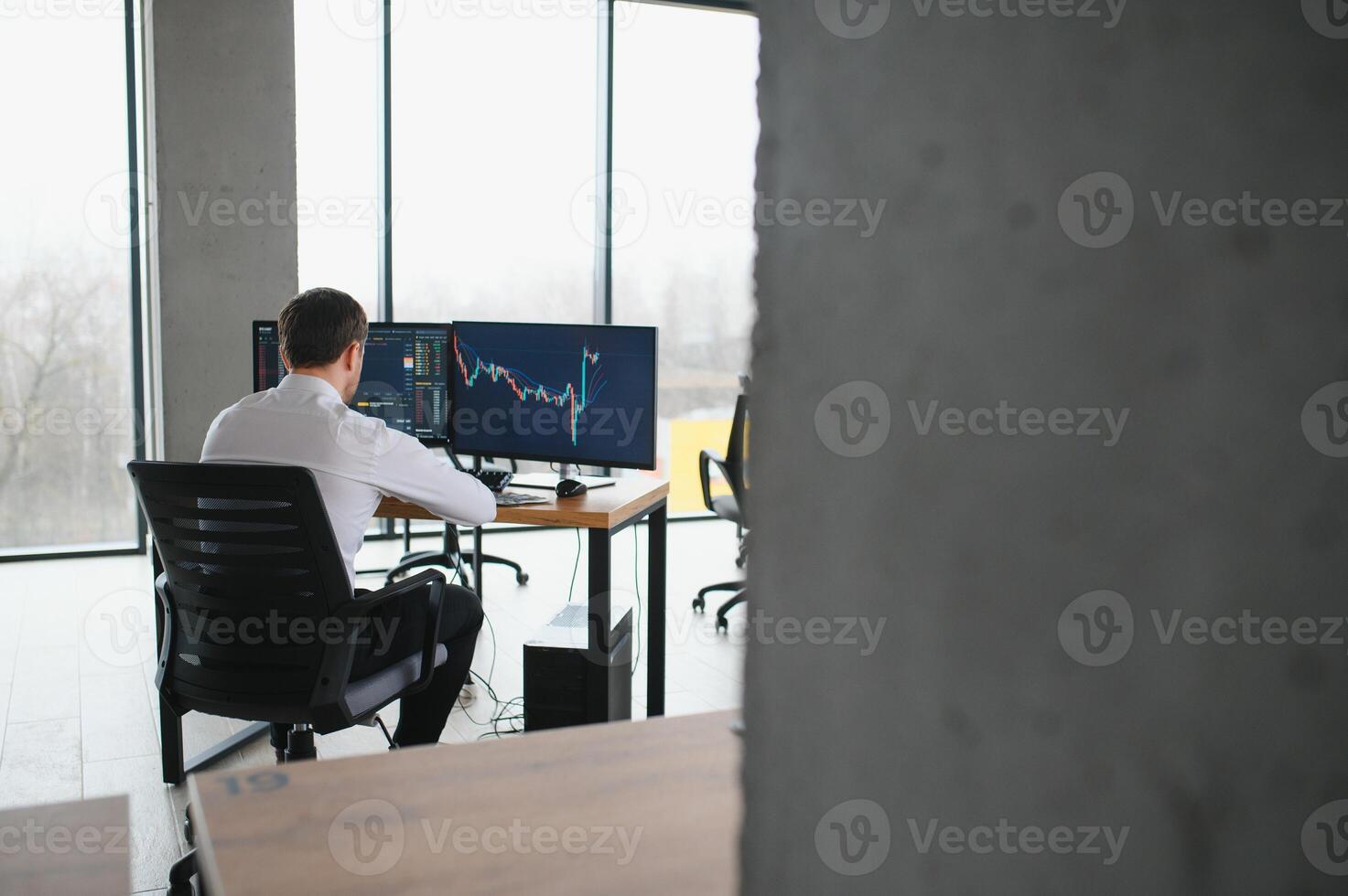 Serious business man trader analyst looking at computer monitor, investor broker analyzing indexes, financial chart trading online investment data on cryptocurrency stock market graph on pc screen. photo