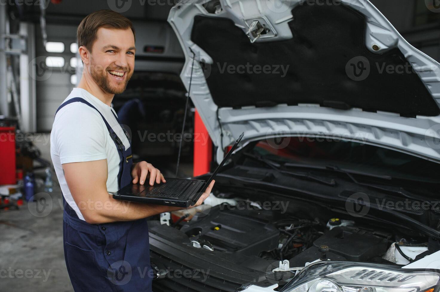 Auto service, repair, maintenance concept. mechanic checks the car, making diagnostics with laptop at the service station. Service maintenance of industrial to engine repair. photo