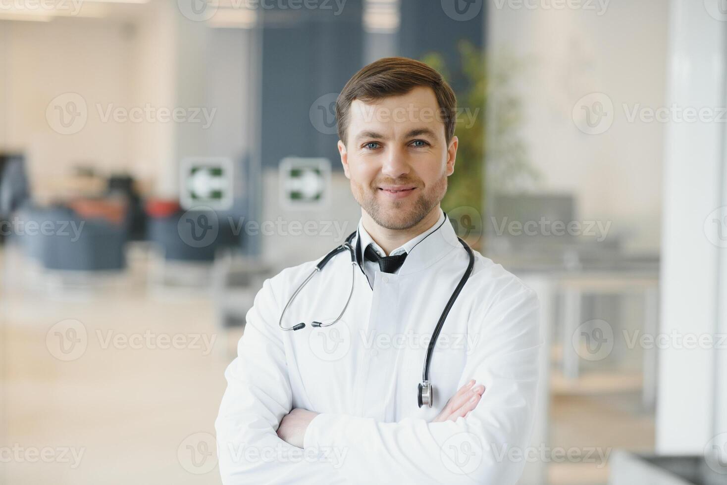Portrait of smiling doctor in uniform standing in medicine clinic hall photo