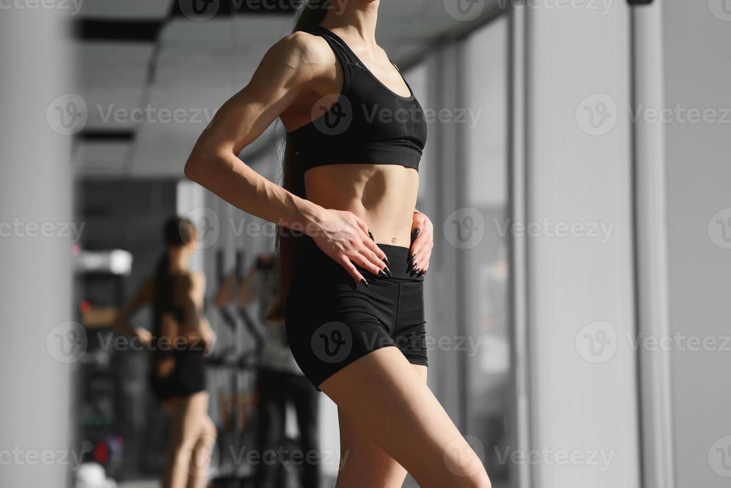 Image of a beautiful strong happy cheerful young sports woman posing at gym photo