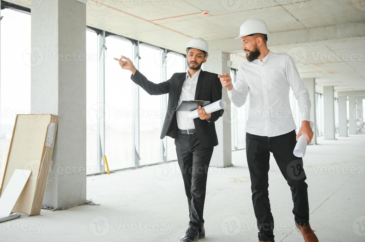 Happy workers at construction site, young civil engineer manager and architects. Indian and Arabian engineers. photo