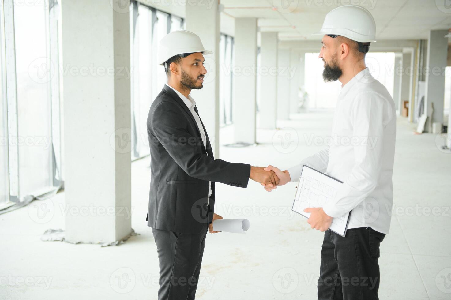 Construction concept of multiracial Engineer and Architect working at Construction Site with blue print photo