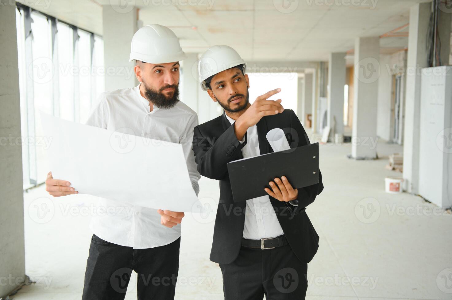 Construction concept of multiracial Engineer and Architect working at Construction Site with blue print photo